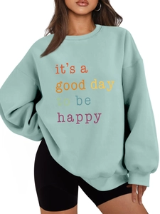 Detail of mint green sweatshirt with colorful it's a good day to be happy letter print