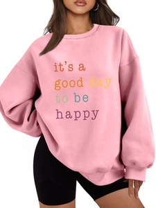 Close-up of pink fleece sweatshirt featuring colorful it's a good day text print