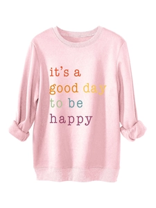 Detail of pink fleece sweatshirt showing ribbed neckline and 'it's a good day' graphic