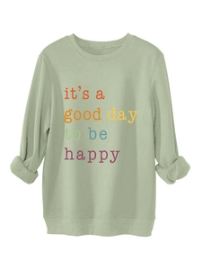 Detail of light green sweatshirt rib-knit cuffs and happy quote graphic print