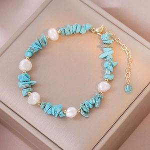 Detail of turquoise stones and baroque pearls necklace with gold adjustable clasp