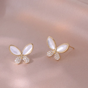 Elegant gold butterfly stud earrings featuring white mother of pearl and zircon stones