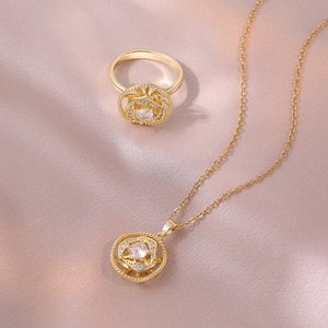 Parure élégante en acier titane doré avec collier fleur rotative et bague assortie