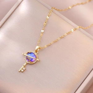 Elegant gold key necklace with planet pendant and purple zircon stones for women