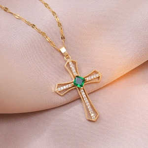 Gold cross necklace with green emerald center and white zircon accents on sequin chain