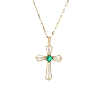 Vintage gold cross necklace with square green emerald and zircons on white background