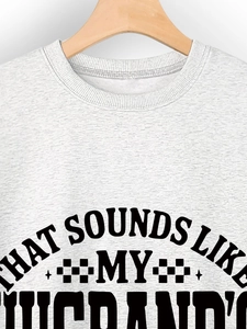 Close-up of ribbed crewneck and vintage letter print on grey cotton sweatshirt