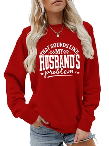 Detail of red crewneck sweatshirt with white slogan print and ribbed cuffs and collar