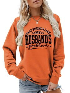 Close-up of orange long-sleeve sweatshirt with black graphic text and ribbed cuffs