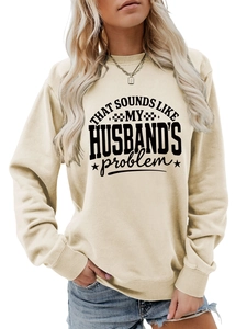 Close-up of beige crewneck sweatshirt featuring black 'That sounds like my husband's problem' text