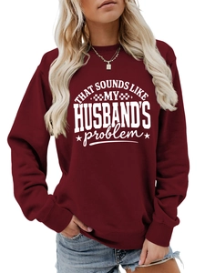 Detail of the white slogan print and ribbed collar on the burgundy crewneck sweatshirt
