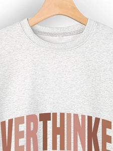 Detail of grey crewneck sweatshirt featuring a textured fabric and Overthinker print