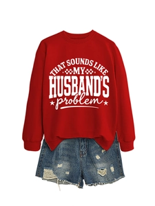 Flat lay of red crewneck sweatshirt with slogan and distressed denim shorts