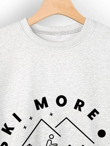 Close-up of crewneck sweatshirt with Ski More mountain print and ribbed collar detail