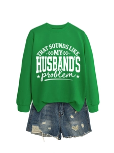 Detail of green long sleeve sweatshirt with white slogan and distressed denim shorts