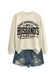 Detail of the crewneck sweatshirt featuring a bold graphic print slogan with stars