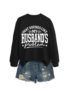 Detail of black crewneck sweatshirt with funny white text print paired with denim shorts