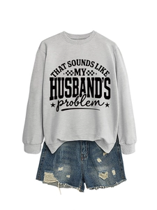 Flat lay of light grey sweatshirt with slogan and distressed denim shorts for casual style