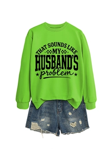 Neon green sweatshirt detail with bold slogan print and distressed denim shorts