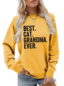 Detail of yellow sweatshirt with BEST CAT GRANDMA EVER print and ribbed cuffs texture