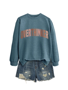 Detail of OVERTHINKER print on a navy crewneck sweatshirt with ribbed cuffs and soft texture