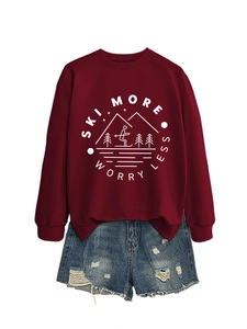 Flat lay of a burgundy sweatshirt with Ski More Worry Less print and denim shorts