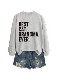 Flat lay of gray sweatshirt with Best Cat Grandma Ever print and ripped denim shorts