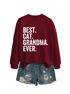 Detail of burgundy sweatshirt featuring Best Cat Grandma Ever print with denim shorts