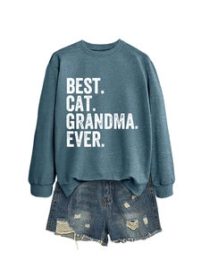 Detail of Best Cat Grandma Ever sweatshirt paired with distressed denim shorts