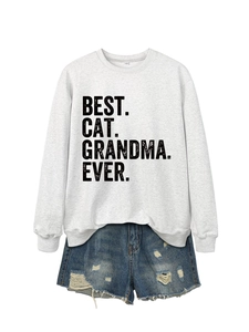 Flat lay of gray BEST CAT GRANDMA EVER sweatshirt and distressed blue denim shorts