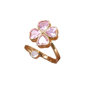 Adjustable gold clover ring with pink heart-shaped stones and a sparkling zircon accent