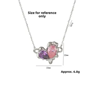 Detailed view of the molten metal heart pendant with pink and purple zircon stones