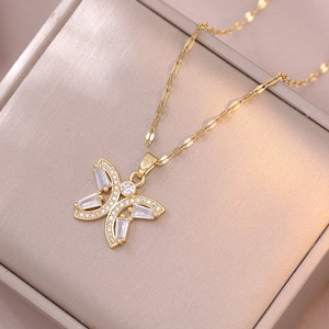 Detailed close-up of golden butterfly pendant necklace with inlaid sparkling zircon crystals