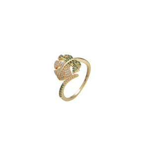 Gold monstera leaf ring with white and green cubic zirconia in a minimalist nature style