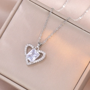 Detailed macro of silver heart pendant necklace with rectangular zircon in luxury jewelry box