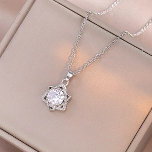 Elegant silver star necklace with zircon pavé pendant on luxury jewelry box