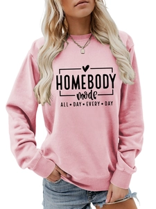 Detailed view of pink sweatshirt with HOMEBODY mode ALL DAY EVERY DAY text and heart print