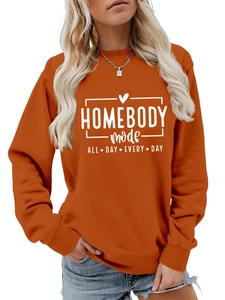Detail shot of caramel crewneck sweatshirt with Homebody Mode All Day Every Day slogan