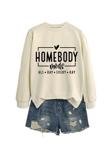 Detail of cream sweatshirt with black letter print paired with blue denim shorts