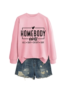 Detailed flat lay of pink long sleeve sweatshirt with text and ripped denim shorts
