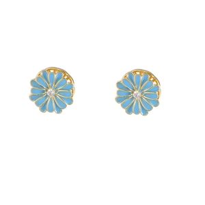 Detailed close-up of daisy stud earrings with sky blue enamel petals and gold finish