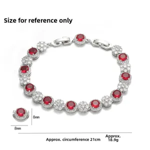 Detail of silver bracelet featuring red round stones with white crystal halo accents