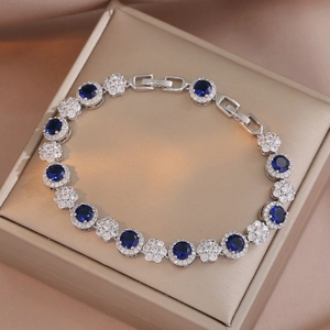 Elegant emerald-style blue zircon bracelet in silver finish on champagne silk