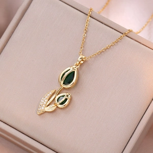 Elegant gold tulip pendant necklace featuring green zircon petals and sparkling accents