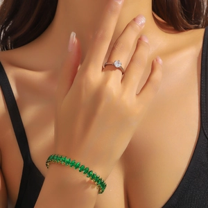 Bracelet en zircon vert émeraude et bague en argent élégants portés par un modèle