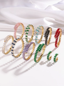 Golden open bracelets with colorful marquise zircons and matching emerald earrings