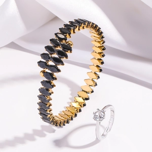 Detail of gold titanium bracelet with marquise black cubic zirconia in leaf pattern