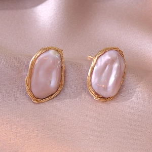 Baroque irregular pearl stud earrings with gold woven wire on silk fabric