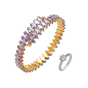 Detail of gold bracelet with marquise-cut purple stones and a classic silver ring