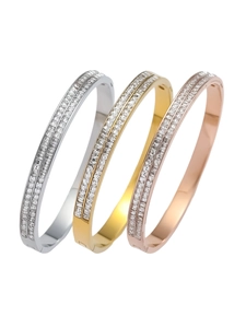 Detailed view of three-piece bangle set in silver, gold, and rose gold with square zircons